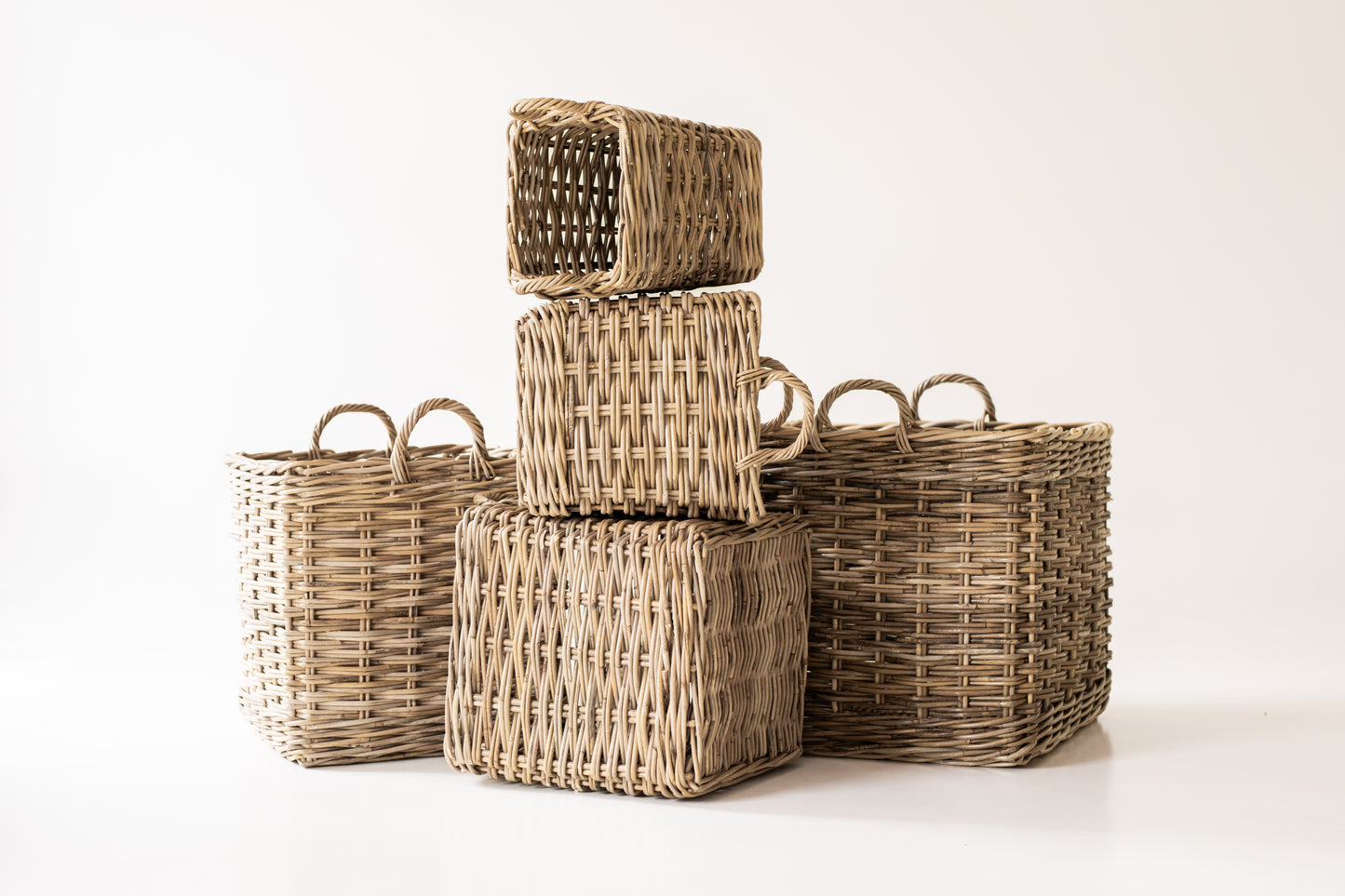 Stack of Rattan Square Storage Basket with Handles on a plain background  – X-Large - XS – front view on white background | Basketly