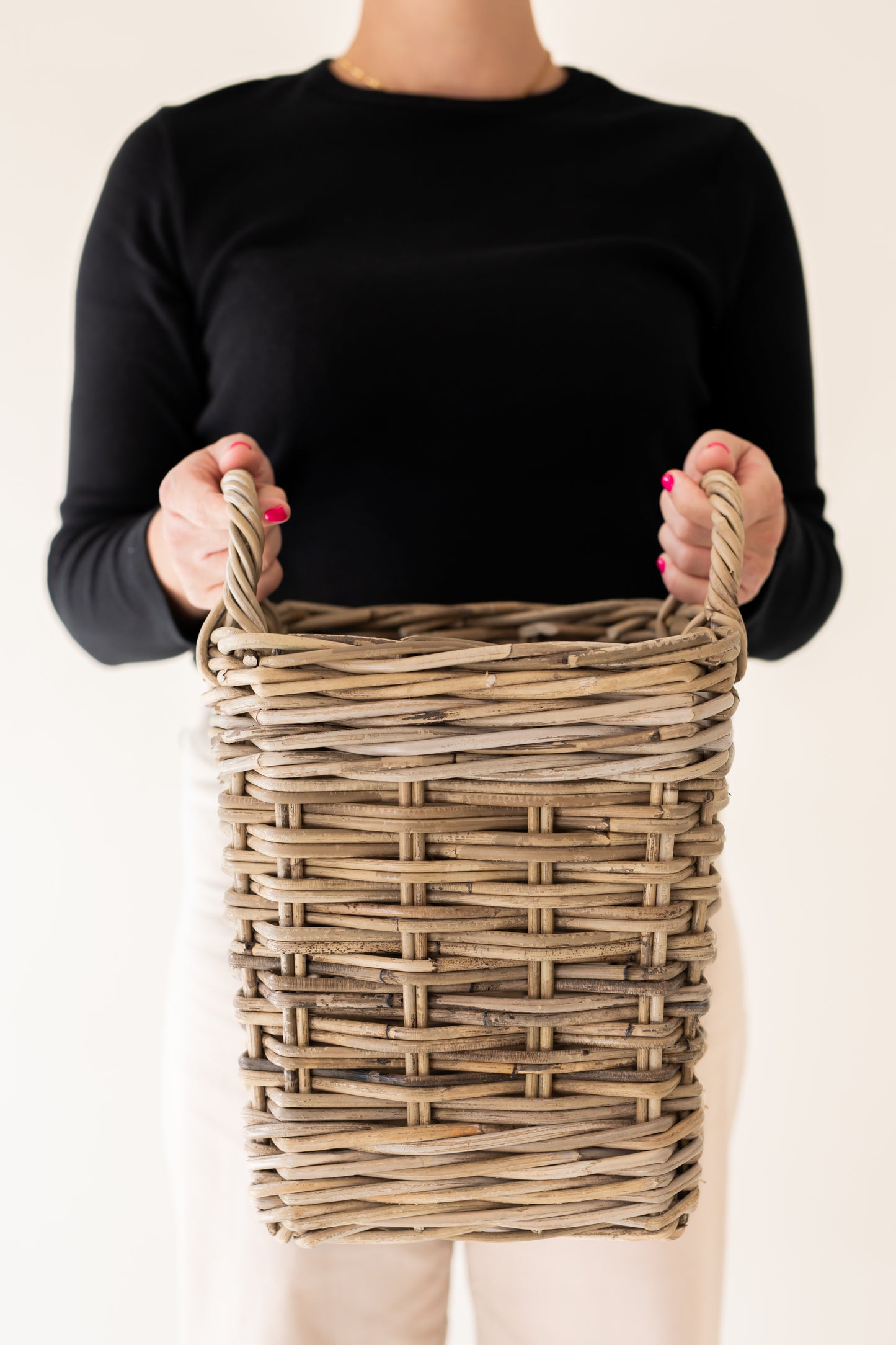 A person holding Rattan Square Storage Basket with Handles - XS with plain background | Basketly