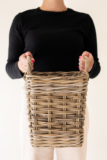 A person holding Rattan Square Storage Basket with Handles - XS with plain background | Basketly