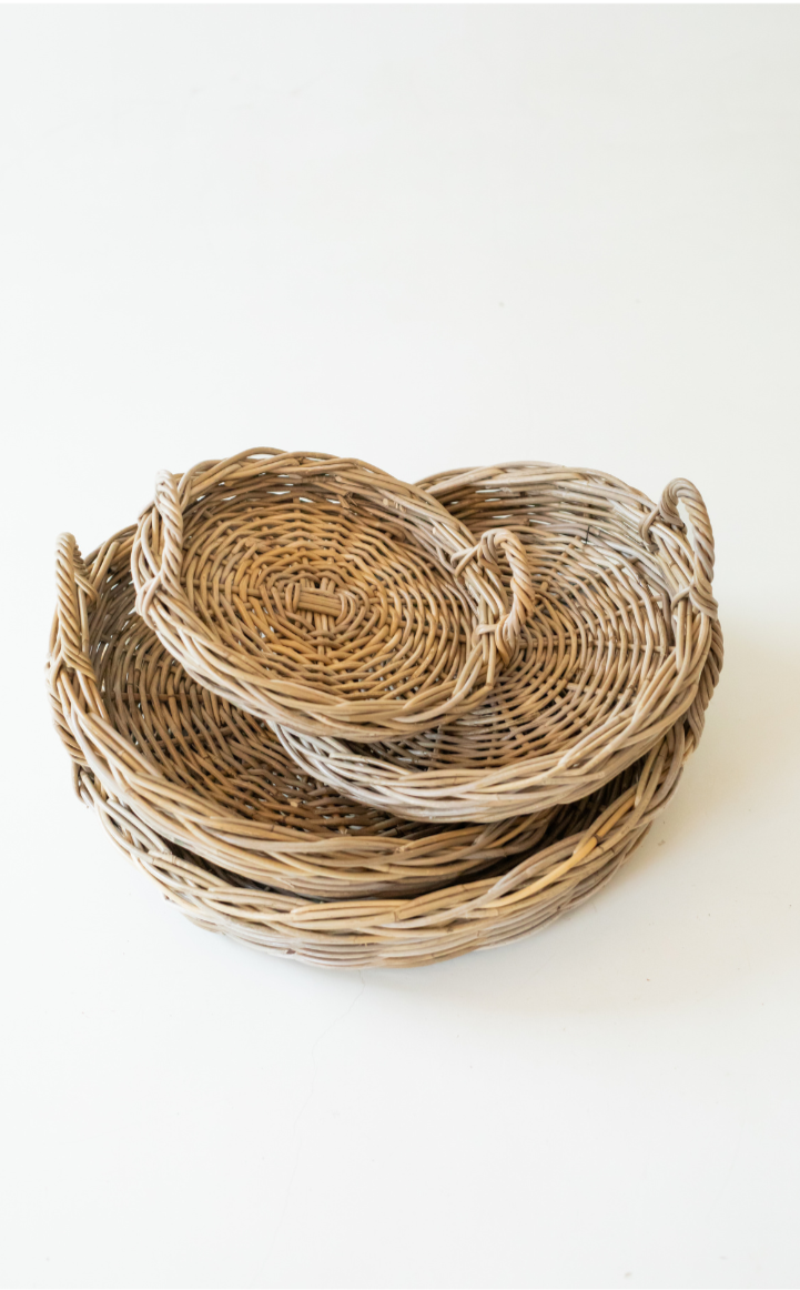 Stack of rattan trays on a white background