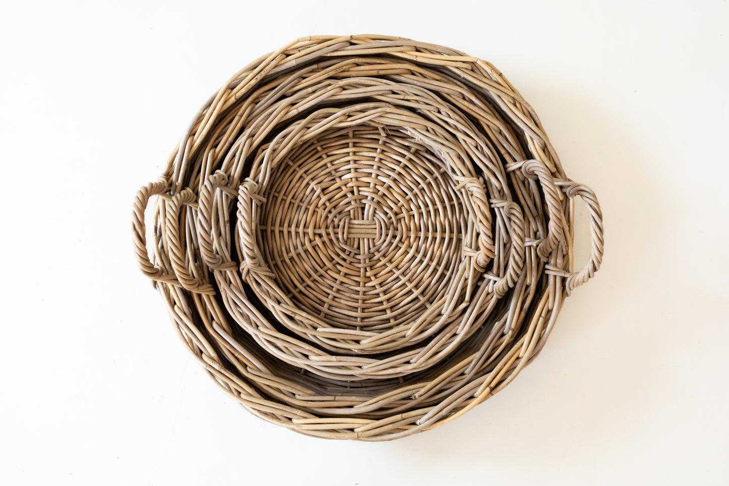 Stack of rattan tray shot from above on a white background