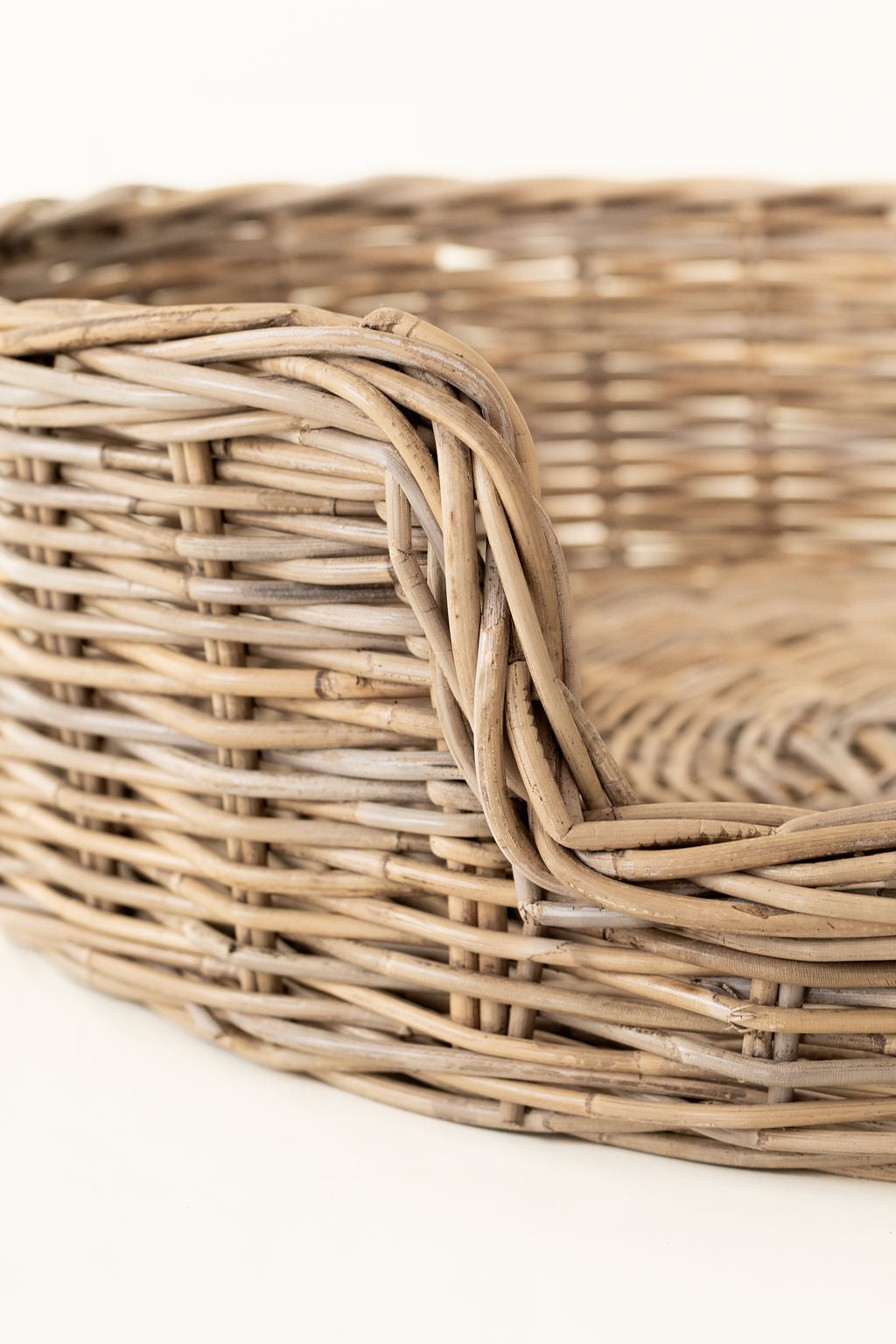 Close-up of a woven wicker basket on a white background
