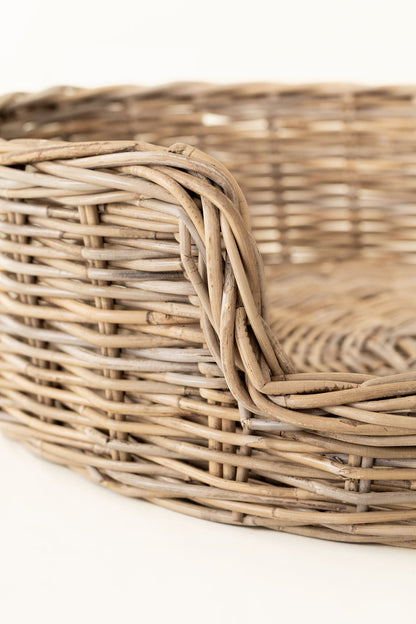 Close-up of a woven wicker basket on a white background
