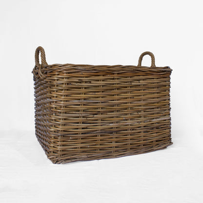 A rectangular rattan storage basket with handles, handwoven from natural materials, with a rustic brown color.